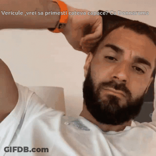 A Man With A Beard Is Looking At The Camera With The Caption Vericule Vrei Sa Primesti Cateva Capace GIF