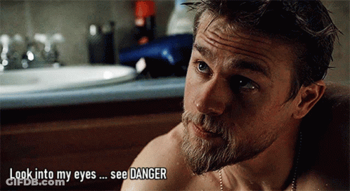 A Man With A Beard Is Looking Into His Eyes With The Words Look Into My Eyes See Danger Above Him GIF