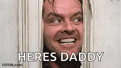 A Man With A Beard Is Looking Through A Hole In A Door And Saying `` Here 'S Daddy '' . GIF