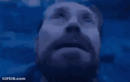 A Man With A Beard Is Looking Up At Something GIF