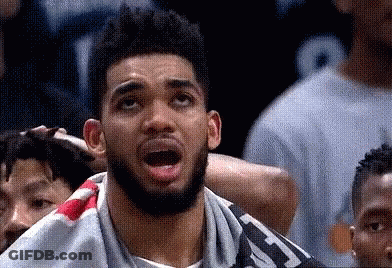 A Man With A Beard Is Looking Up With His Mouth Open . GIF