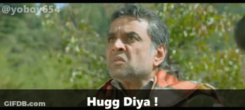 A Man With A Beard Is Looking Up With The Words Hugg Diya Above Him GIF