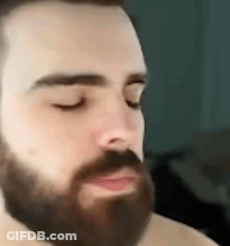 A Man With A Beard Is Making A Funny Face . GIF