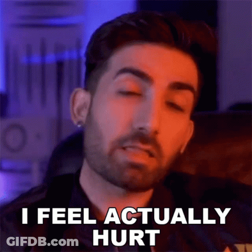 A Man With A Beard Is Making A Funny Face And Saying `` I Feel Actually Hurt '' With His Eyes Closed . GIF