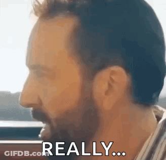 A Man With A Beard Is Making A Funny Face And Says `` Really '' . GIF