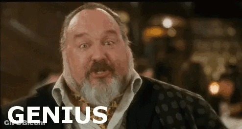 A Man With A Beard Is Making A Funny Face And The Word Genius Is On The Screen . GIF