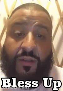 A Man With A Beard Is Making A Funny Face And The Words Bless Up Are On The Bottom Of His Face . GIF