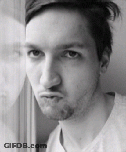 A Man With A Beard Is Making A Funny Face In A Black And White Photo GIF