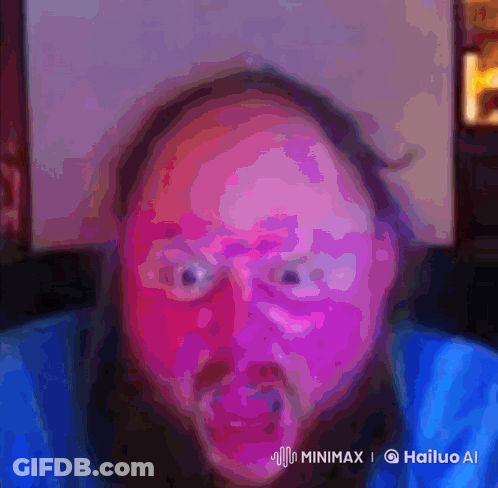 A Man With A Beard Is Making A Funny Face In A Colorful Painting GIF