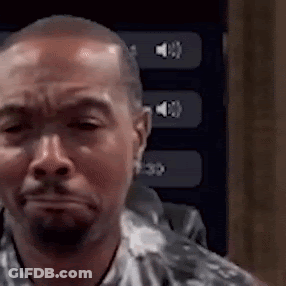 A Man With A Beard Is Making A Funny Face In Front Of A Screen With Buttons On It . GIF