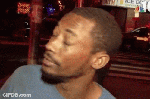 A Man With A Beard Is Making A Funny Face In Front Of An Atm . GIF