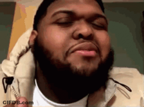 A Man With A Beard Is Making A Funny Face . GIF