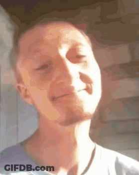 A Man With A Beard Is Making A Funny Face With His Eyes Closed And His Mouth Open . GIF