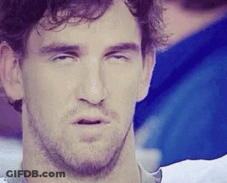 A Man With A Beard Is Making A Funny Face With His Eyes Closed And His Mouth Open . GIF