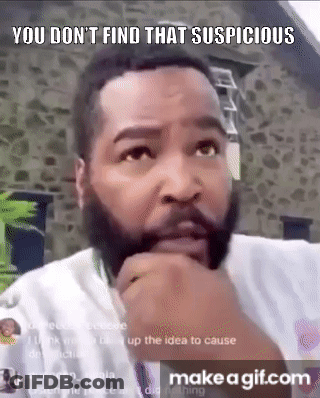 A Man With A Beard Is Making A Funny Face With His Hand On His Chin And A Stone Wall In The Background . GIF