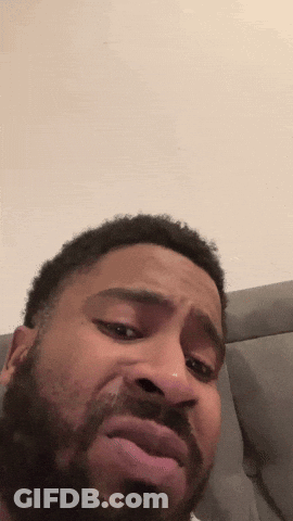 A Man With A Beard Is Making A Funny Face With His Mouth Open GIF