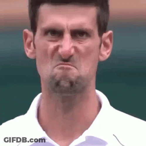 A Man With A Beard Is Making A Funny Face With His Mouth Open . GIF