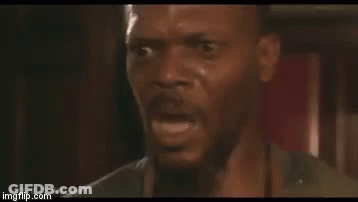 A Man With A Beard Is Making A Funny Face With His Mouth Open . GIF