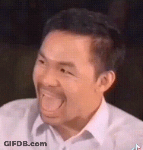 A Man With A Beard Is Making A Funny Face With His Tongue Out . GIF