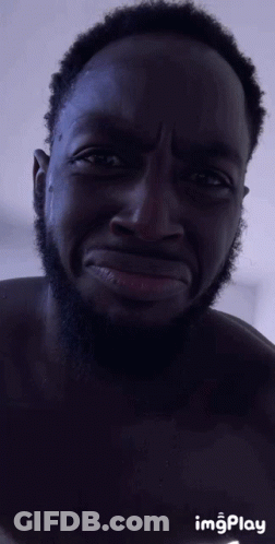 A Man With A Beard Is Making A Funny Face With Imgplay In The Corner GIF