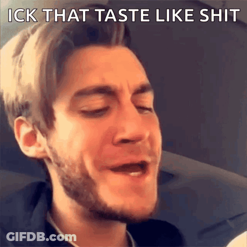 A Man With A Beard Is Making A Funny Face With The Words " Ick That Taste Like Shit " Above Him GIF