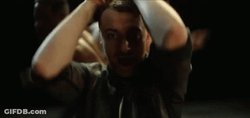 A Man With A Beard Is Making A Hand Gesture With His Hands GIF
