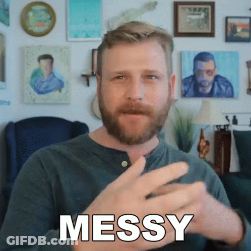 A Man With A Beard Is Making A Messy Gesture With His Hands GIF