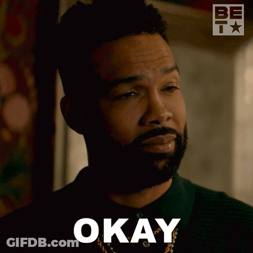 A Man With A Beard Is Making An Okay Sign With His Eyes Closed GIF