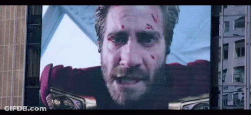 A Man With A Beard Is On A Large Screen GIF