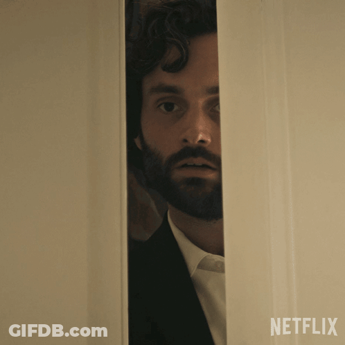 A Man With A Beard Is Peeking Out Of A Door That Says Netflix On The Bottom GIF