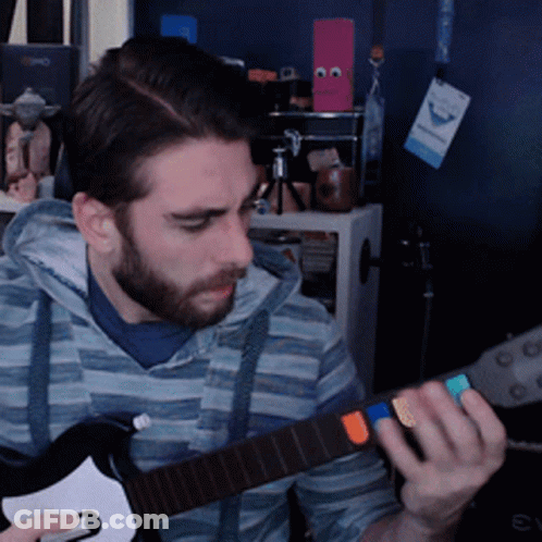 A Man With A Beard Is Playing A Guitar In Front Of A Sign That Says ' Evo ' On It GIF