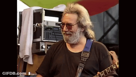 A Man With A Beard Is Playing A Guitar With A Blue Strap GIF