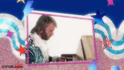 A Man With A Beard Is Playing A Piano In A Frame GIF