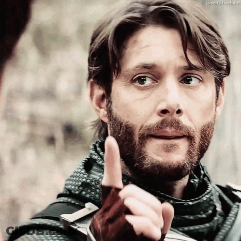 A Man With A Beard Is Pointing His Finger At Something GIF