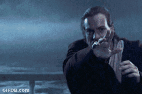 A Man With A Beard Is Pointing His Finger At Something GIF