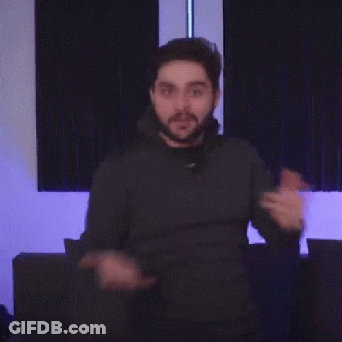 A Man With A Beard Is Pointing His Finger At The Camera . GIF