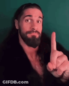 A Man With A Beard Is Pointing His Finger Up . GIF