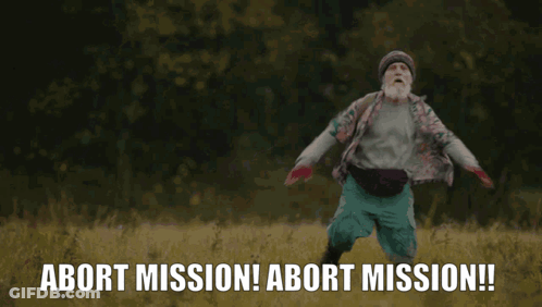 A Man With A Beard Is Running In A Field With The Words Abort Mission Behind Him GIF