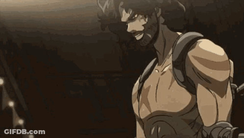 A Man With A Beard Is Screaming In A Boxing Ring While Holding A Sword . GIF
