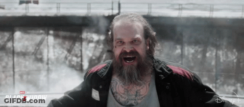 Bearded Man Screaming In Front Of Black Widow Ad GIF
