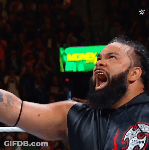 A Man With A Beard Is Screaming In Front Of A Green Sign That Says ' More ' GIF