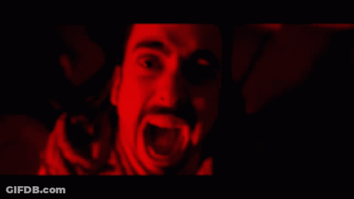 A Man With A Beard Is Screaming In The Dark GIF