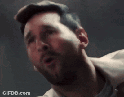 A Man With A Beard Is Screaming With His Mouth Wide Open GIF