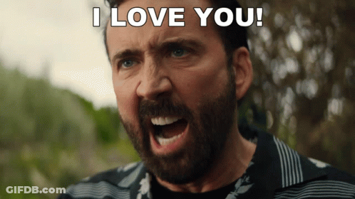 A Man With A Beard Is Screaming With The Words I Love You Behind Him GIF