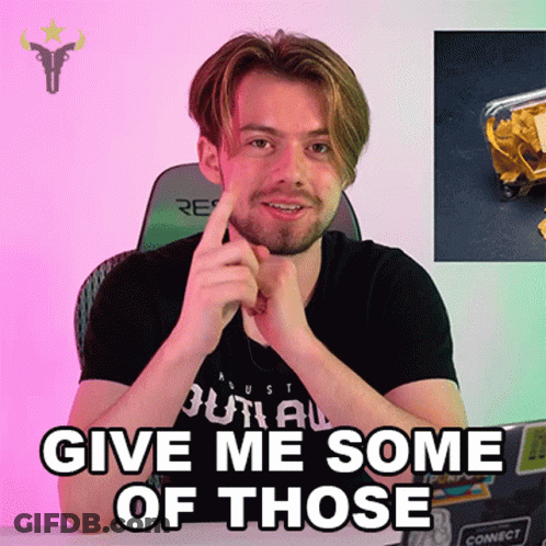 A Man With A Beard Is Sitting At A Desk With His Hand On His Chin And Says Give Me Some Of Those GIF
