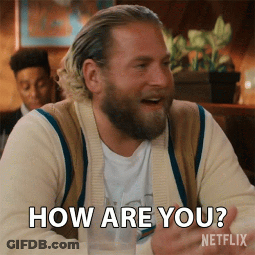 A Man With A Beard Is Sitting At A Table And Says How Are You Netflix GIF