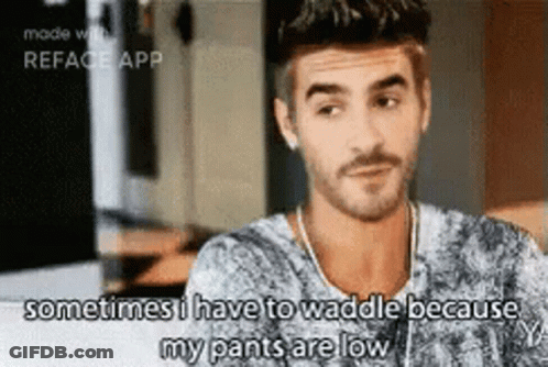 A Man With A Beard Is Sitting At A Table And Says Sometimes I Have To Waddle Because My Pants Are Low GIF