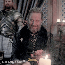A Man With A Beard Is Sitting At A Table With A Candle And Says " Good " GIF