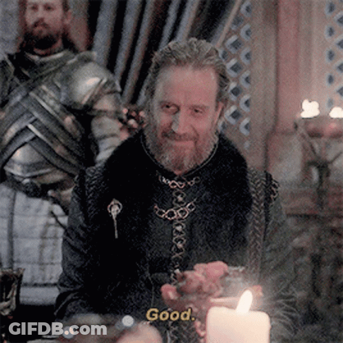 A Man With A Beard Is Sitting At A Table With A Candle And Says " Good " GIF