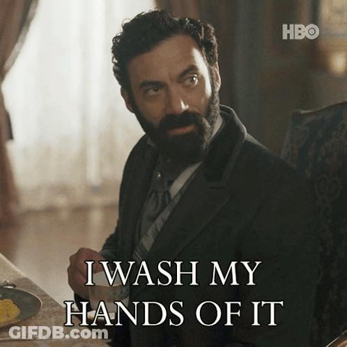 A Man With A Beard Is Sitting At A Table With A Cup Of Coffee And Says I Wash My Hands Of It GIF